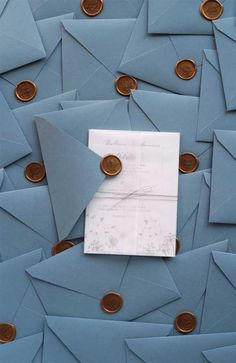 blue envelopes with coins scattered around them and a piece of paper in the middle