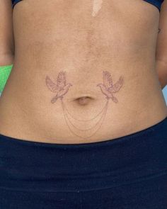 a woman's stomach with two small birds on the side and an arrow drawn across it