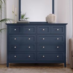 a blue dresser with a large mirror on top