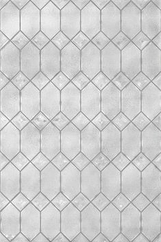 a white tiled wall with small squares on it