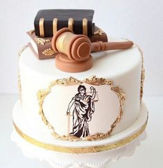 a cake decorated with a judge's gavel and law book on top of it