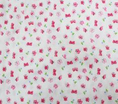 a white fabric with pink flowers and green leaves on the bottom, in front of a light blue background