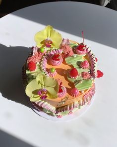 there is a cake on the table with pink and green frosting