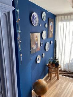 a room with blue walls and plates on the wall