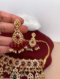 Red Stone Red Monalisa CZ High Neck Choker with matching EarringsColor : GoldenSize : Choker Length : Approx 14 Inches; Earrings Length : 2.5 InchesStones : CZ Red Stone Red Monalisa Beads Pearls Luxury Red Tilla Jewelry, Luxury Red Sets With Stone Work, Luxury Red Kundan Chandbalis, Neck Choker, Red Stone, Social Events, Indian Jewelry, Choker, High Neck