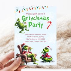 a hand holding up a christmas party card with the grinch family sitting in chairs