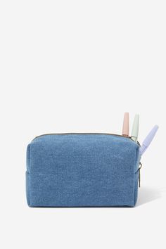 a blue denim pencil case with two pens sticking out of it