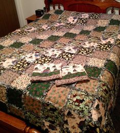 a bed with a quilt on top of it