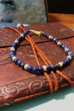 This bracelet is elegantly accented with gold glass beads to make the gold in the lapis lazuli stand out.  Lapis Lazuli is a dark blue crystal with flecks of pyrite in it. It is a stone used for wisdom and truth. It aids in intellectual analysis and good judgement. This stone is typically used for the third eye.  It measures at 7.5 inches.  If you have any questions, please feel free to contact me.  Thanks! :) Gold Bracelets With Lapis Lazuli And Natural Stones, Gold Beaded Lapis Lazuli Bracelets, Gold Lapis Lazuli Bracelets For Gift, Gold Lapis Lazuli Beaded Bracelets With Round Beads, Hand-strung Gold Lapis Lazuli Bracelets, Handmade Gold Beaded Lapis Lazuli Bracelets, Gold Bracelets With Polished Beads For Healing, Gold Beaded Bracelets With Natural Stones For Meditation, Gold Beaded Bracelet With Natural Stones For Meditation