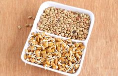 two white bowls filled with nuts on top of a wooden table