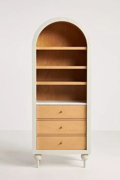 an arch shaped bookcase with drawers on each side