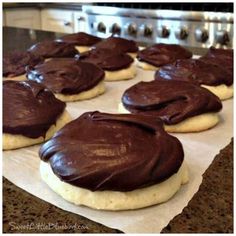 cookies with chocolate frosting are on a baking sheet