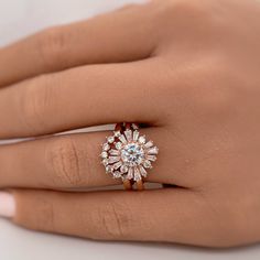 a woman's hand with a diamond ring on it