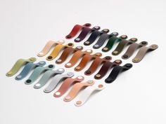 a group of different colored handles on a white surface with no one in the photo