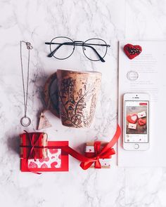 the contents of a valentine's day gift laid out on a marble counter top