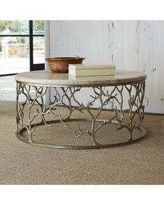 a table that has some books and a bowl on it in front of a window