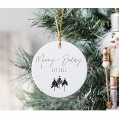 a personalized ornament hanging on a christmas tree with a nutcracker