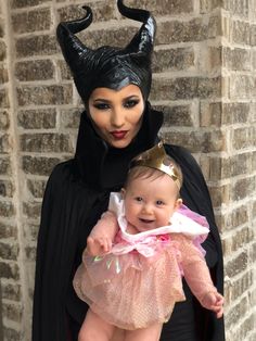 a baby in a costume is being held by a maleficent