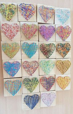 string art hearts are arranged on wooden blocks