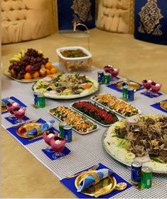 a table filled with lots of food on top of a blue and white table cloth