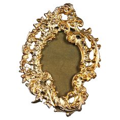 an ornate gold frame is shown against a white background with the image in it's center