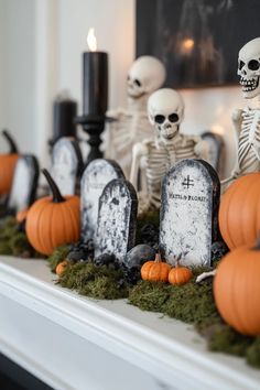 halloween decorations with skeletons and pumpkins on the mantle