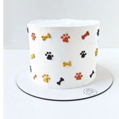 a white cake with dog paw prints on it