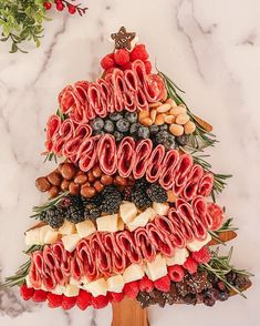 a christmas tree made out of meats and fruits