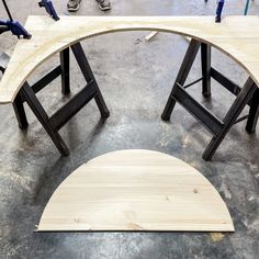 two wooden chairs sitting on top of a cement floor