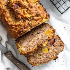 two slices of banana bread sitting on top of a white napkin next to a knife