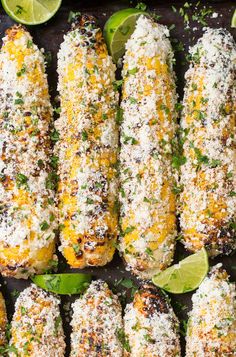 grilled corn on the cob with limes, parmesan cheese and seasoning