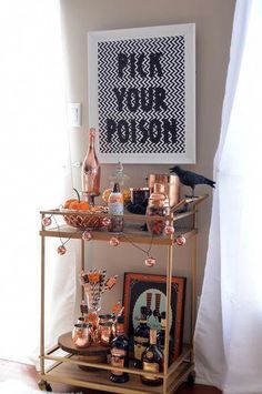 a bar cart with bottles and glasses on it