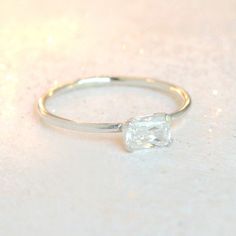 Our diamond ring in sterling silver is just right - bold yet simple enough for every day wear. It features a 6x4mm rectangle cubic zirconia diamond, prong set. This emerald cut rectangle cz diamond compliments any of our other stacking rings! Mix and match with an array of gemstone rings for a fresh, layered look. Find all our other birthstone stacking rings here: http://etsy.me/1MTC9gS {DETAILS}: * cubic zirconia diamond 6x4mm * 1.3mm band * sterling silver band & setting ►You might also ad Everyday Silver Solitaire Stackable Rings, Everyday Silver Stackable Solitaire Rings, Minimalist Silver Solitaire Stackable Rings, Minimalist Sterling Silver Birthstone Ring With Single Diamond, Minimalist Silver Stackable Solitaire Rings, Simple Silver Stackable Rings For Everyday, Silver Stackable Rings With Single Diamond In Sterling Silver, Silver Sterling Stackable Rings With Single Diamond, Classic Everyday Sterling Silver Birthstone Ring