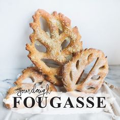 some pretzels sitting on top of a white cloth with the words, sunday fougasse