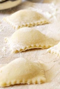 three uncooked dumplings sitting on top of a table