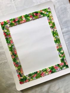 a white plate topped with flowers on top of a table