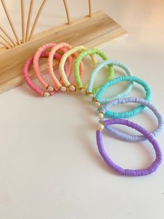 "This listing is for (1) 6mm Heishi Bracelet with a Fresh Water Pearl in the middle! This is colorful bracelet and is a fun addition to any stack for a little summer flare! It is completely customizable to your liking. If you would like multiple colors please state so in the \"notes\" section! You pick the color discs - we deliver exactly that! Please include all of this in the notes section! This bracelet is made of \"heishi\" beads - made from polymer clay + and gold discs. The gold discs are Clay Was Bracelets, Peach Clay Bead Bracelet, Bright Clay Bead Bracelets, Clay Bead Accessories, Heishi Bracelet Ideas Preppy, Cute Summer Clay Bead Bracelets, Spring Clay Bead Bracelets, Bracelets Ideas Beaded, Clay Bracelets Diy