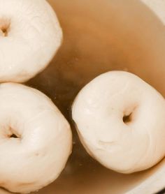 three doughnuts sitting in a pot of water