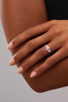 a woman's hand with a diamond ring on it