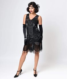 Get ready for an evening of cocktails and jazz in an outfit that epitomizes the romance of the 1920s. Unique Vintage’s The Bosley cocktail dress is an authentic replica of the beaded and fringed flapper frocks that made the Roaring ‘20s such an important time in fashion history, combined with a modern fit that is flattering on anyone’s unique figure. The shift shape hits just below the knees and features a V-neck bodice with slightly lower back, and its wide scalloped hemline is accented by bead Fitted Beaded Fringe Flapper Dress For Costume Party, Embellished Fitted Flapper Dress For Costume Party, Fitted Flapper Dress With Beaded Fringe For Costume Party, 1920s Style Fitted Dress With Beaded Fringe, Flapper Dress With Beaded Fringe For Night Out, Night Out Flapper Dress With Beaded Fringe, Summer Gatsby Flapper Dress For Night Out, Black 1920s Flapper Dress For Costume Party, Gatsby Style Flapper Dress For Party Season