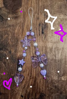 a wooden table topped with purple and white glass beads next to other items on top of it