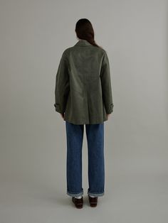 This loose fitting jacket is made with premium coated fake leather fabric and is accentuated with comfortable dropped shoulders and wide side pockets.  - Semi oversized silhouette- Casual open collars and horn button fastenings- Strap detail at neckline and cuffs- Soft and matte texture- Versatile styling and easy layering Olive Outerwear With Welt Pockets For Work, Olive Outerwear With Button Closure And Lapel Collar, Olive Lapel Collar Outerwear With Button Closure, Fall Olive Outerwear With Welt Pockets, Olive Outerwear With Pockets And Lapel Collar, Olive Workwear Outerwear With Flap Pockets, Olive Lapel Collar Outerwear For Work, Olive Single-breasted Outerwear With Lapel Collar, Matte Texture