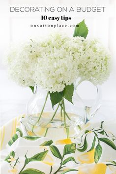 a vase filled with white flowers sitting on top of a yellow and white table cloth