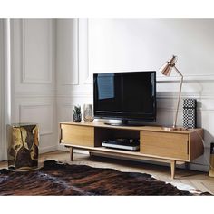 a living room scene with focus on the entertainment center and rug in the foreground