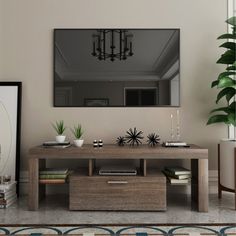 a living room with a large mirror on the wall next to a coffee table and plant