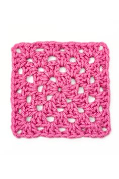 a pink crocheted square on a white background