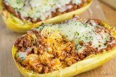 two stuffed spaghetti dishes sitting on top of a wooden table