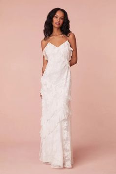 LoveShackFancy's best-selling Rialto Dress returns for the season in a new timeless, white colorway designed with floral applique lace all over giving this fan-favorite a delicate look. Perfect for our brides, this stunning maxi features a subtle amount of sheerness giving it a slightly sexy, but still modest look. The piece features overlapping, asymmetrical ruffles at the neckline that continue to descend through the entire skirt. Slightly fitted, the dress includes a side seam zipper for closure. 54% Nylon/46% Cotton Combo: 100% Silk Lining: 100% Polyester Dry Clean Only Measurements based on Size 4 Body Length: 62" Chest: 34" Waist: 29" Low Hip: 38 1/2" White Ruffle Maxi Dress, Long White Graduation Dress, Ruffle White Dress, Country Graduation, Ruffle Lace Dress, Long White Dresses, Rose Latte, Applique Lace, White Ruffle Dress