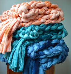 there are many different colored yarns stacked on top of each other