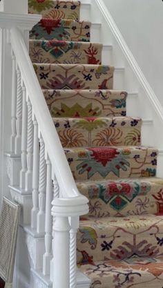 the stairs are decorated with colorful rugs